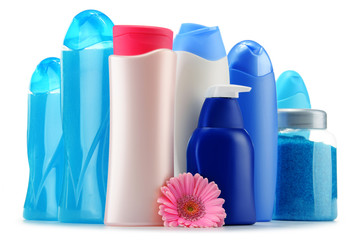 Plastic bottles of body care and beauty products over white