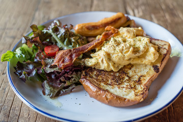 French toast breakfast served with omelet sausage and bacon