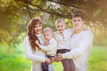 beautiful happy family in sweaters with his two sons in the fore