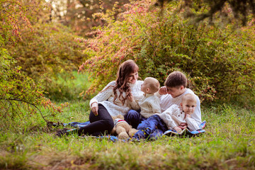 Fototapeta premium beautiful happy family in sweaters with his two sons in the fore