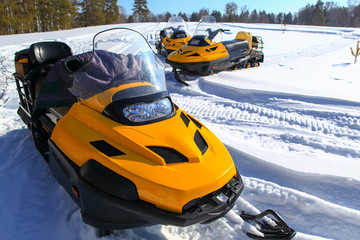 people driving  snowmobile in winter mountain 