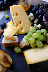 cheese and fruits on slate