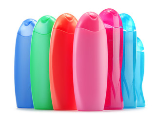 Plastic bottles of body care and beauty products over white