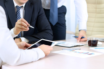 Business colleagues working and analyzing financial figures on a