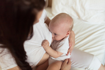 Baby with her mother , light,   breastfeeding