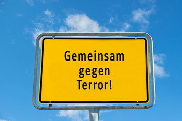 Signboard against cloudy sky