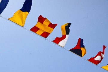 The row of nautical flags closeup on ship