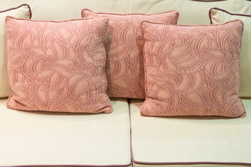 floral pattern pink pillows on light green sofa