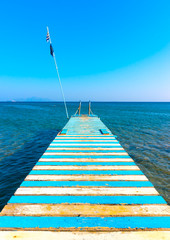 Beautiful wooden pier at a beach in kefalos area in Kos island in Greece