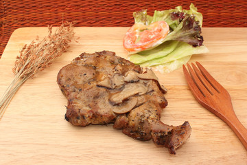 Pork steak decorated on wood