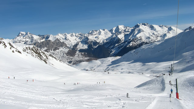 skiers on the ski resort of Formigal in Aragon - Spain, snowy mountain landscape, nature and sport background