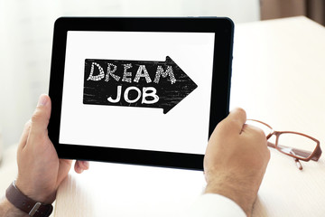 Dream job concept. Male hands holding tablet, close-up