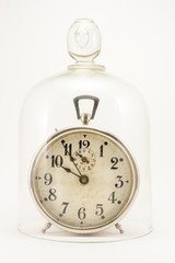 Vintage clock under a glass bell