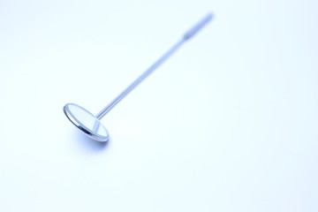 Steel laryngeal mirror in the light-box  