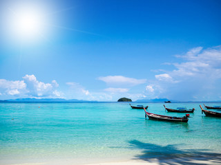 Beach and boats with sun light ray background