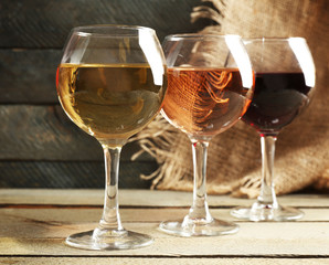 Composition of wine glasses on wooden background