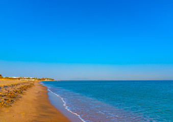 Fototapeta na wymiar the beautiful long sandy beach at Chelona cape near Kardamaina village at Kos island in Greece