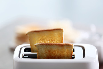 A couple of crusty toasts in the toaster, close-up