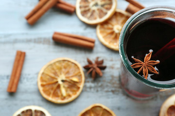 Fototapeta na wymiar Tasty mulled wine and spices, on blue wooden background, close-up