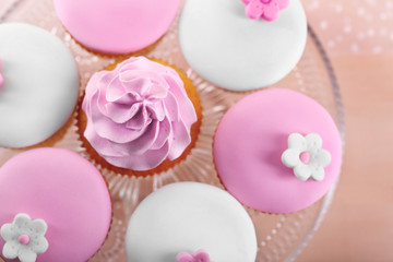 Tasty cupcake on stand, close-up