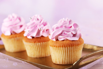 Tasty cupcakes on light background