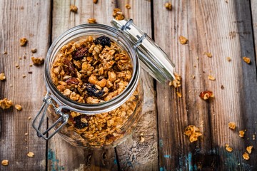 homemade granola with raisins and nuts in a glass jar