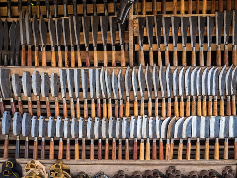Many kind of knifes on wooden shelf