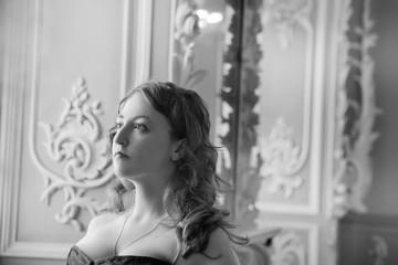 Naklejka premium beautiful woman wearing corset posing in palace