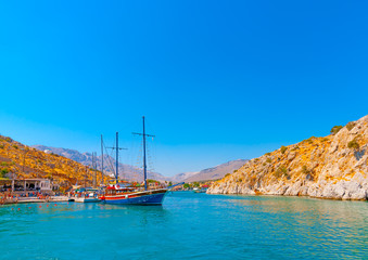 traditional wooden big sailing boat  docked at the port of Vathi village in Kalymnos island in Greece