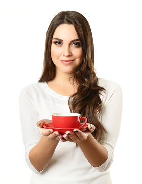 Woman holds cup of coffee and plate in hands isolated on white background, close up