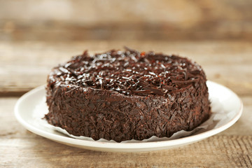 Tasty chocolate cake on wooden background
