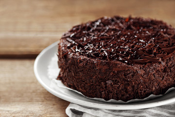 Tasty chocolate cake on wooden background