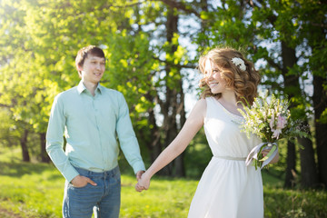 Fototapeta na wymiar Young couple in love walking, spring park