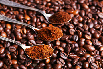 Spoons with coffee on coffee beans, close up