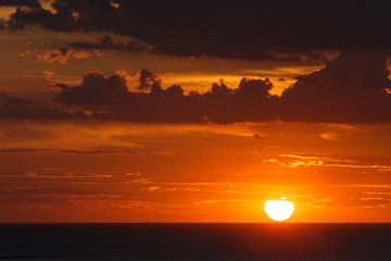 Orange sunset and cloud over sea