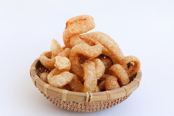 Crispy Pork Skin , Thai style food  in a wicker basket isolated over the white background 