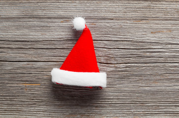 Obraz na płótnie Canvas Single Santa Claus red hat on wooden background