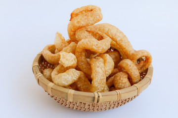Crispy Pork Skin , Thai style food  in a wicker basket isolated over the white background 