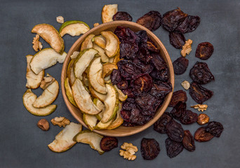dried fruits in the wooden bowl. Top view