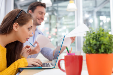 Attractive young designers are discussing their work