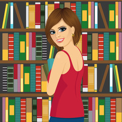 librarian woman in library holding books