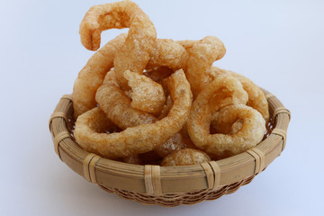 Crispy Pork Skin , Thai style food  in a wicker basket isolated over the white background