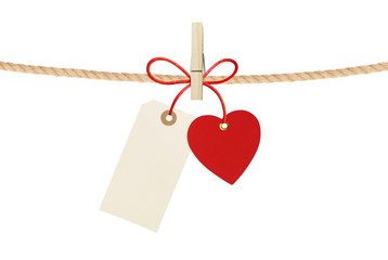 Paper heart and empty tag hang on cord isolated on white backgro