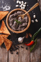 Frijoles refritos with ingredients close-up. vertical top view
