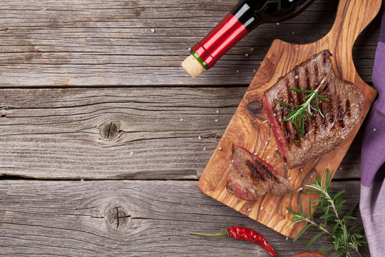 Grilled beef steak with rosemary, salt and pepper and wine