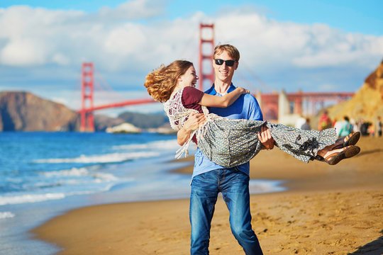 Romantic loving couple having a date on Baker beach in San Francisco