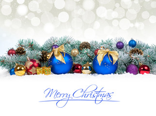 Fototapeta na wymiar Christmas baubles and blue balls with snow fir tree