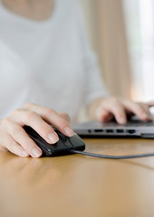 Female hand touching computer mouse closeup