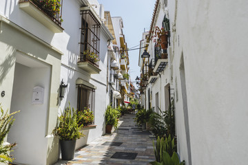 Fototapeta na wymiar typical Andalusian streets and balconies with flowers in Marbell