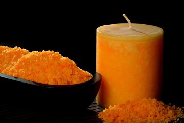 Orangefarbenes Badesalz mit Kerze
